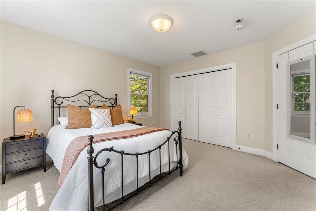 33 Bond Street Needham, MA 02492 - Photo 31 of 35 a bedroom with a bed and a night stand