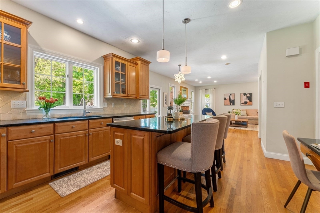 33 Bond Street Needham, MA 02492 - Photo 9 of 35 a large kitchen with kitchen island a large island in it