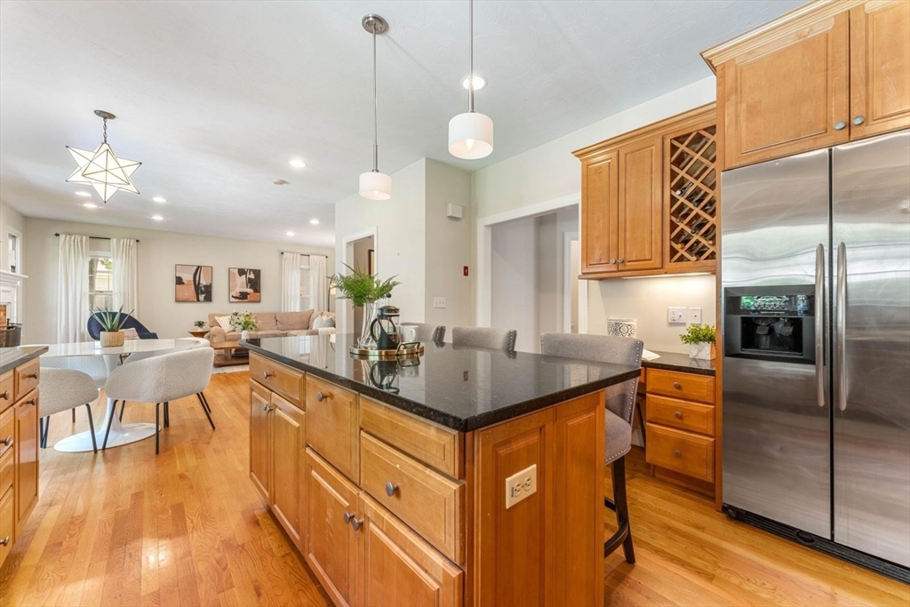 33 Bond Street Needham, MA 02492 - Photo 10 of 35 a large kitchen with kitchen island a large counter top space a sink stainless steel appliances and cabinets