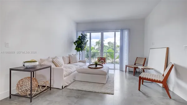 a living room with furniture and a large window