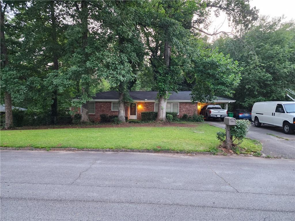 441 Hammett Drive Decatur, GA 30032 - Photo 1 of 1 a front view of a house with a garden and trees