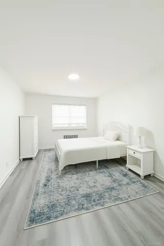 a view of a bedroom with furniture and window