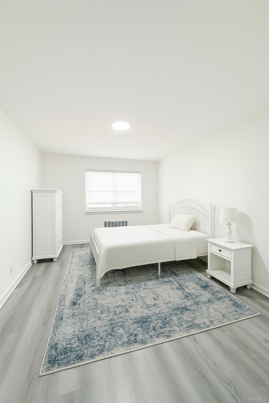 69-09 150th Street, Unit 320A Queens, NY 11367 - Photo 6 of 7 a view of a bedroom with furniture and window