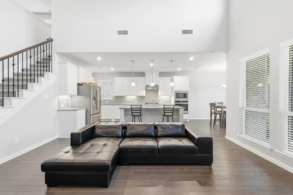 1708 Bird Cherry Lane Prosper, TX 75078 - Photo 11 of 32 a living room with furniture and a table