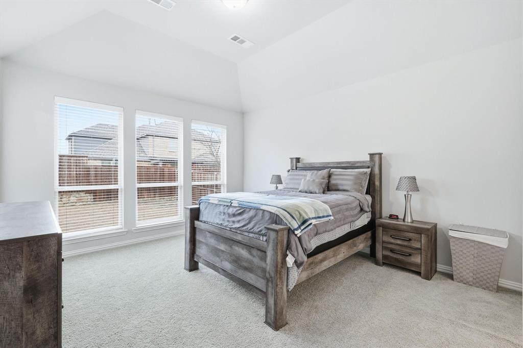 1708 Bird Cherry Lane Prosper, TX 75078 - Photo 13 of 32 a bed sitting in a room next to a window