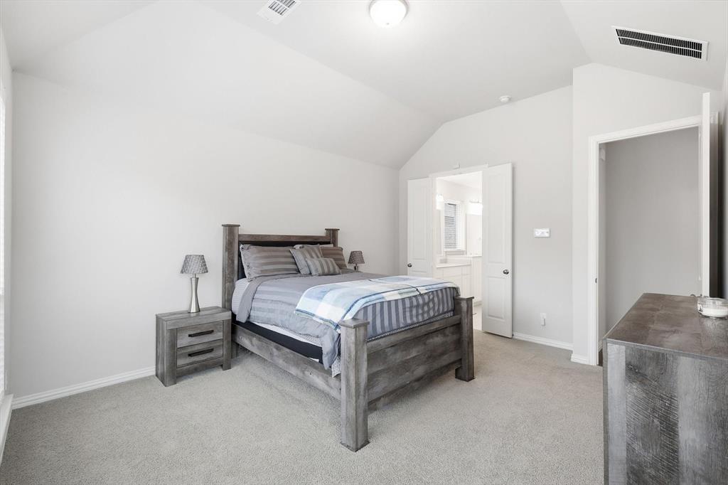 1708 Bird Cherry Lane Prosper, TX 75078 - Photo 14 of 32 a bedroom with a bed and a couch