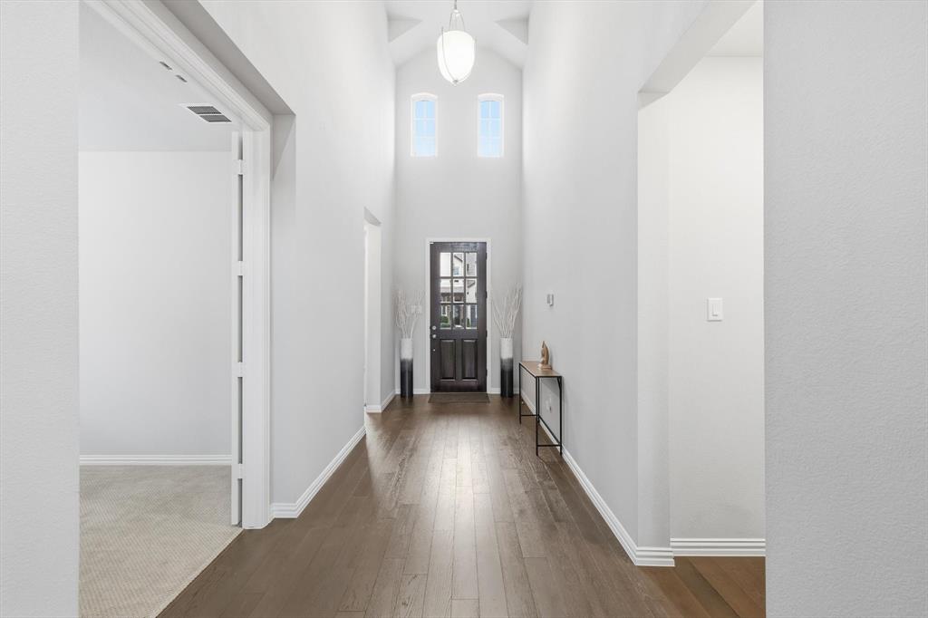 1708 Bird Cherry Lane Prosper, TX 75078 - Photo 2 of 32 a view of a hallway with wooden floor