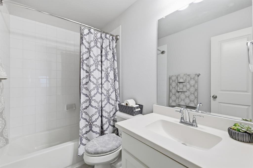 1708 Bird Cherry Lane Prosper, TX 75078 - Photo 23 of 32 a bathroom with a sink toilet and shower