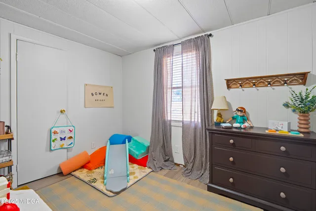a bedroom with toys and stairs