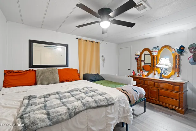 a bedroom with a bed and a window