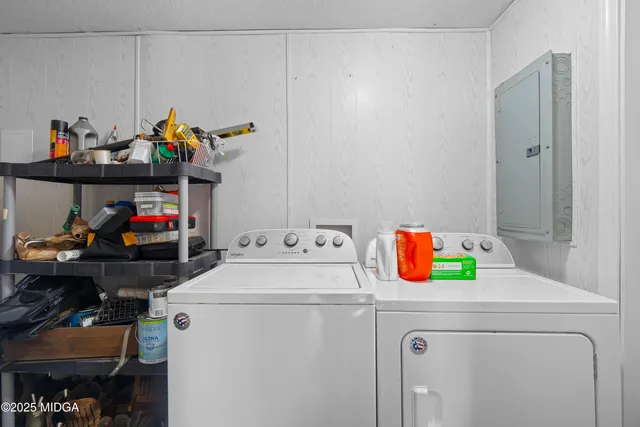 a view of a patio with a table chairs and a barbeque
