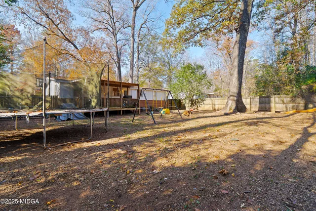 a view of a house with a yard covered in snow
