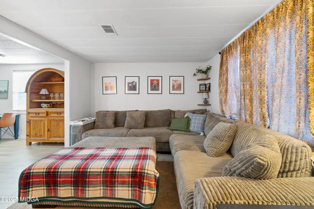 a living room with a couch and a window