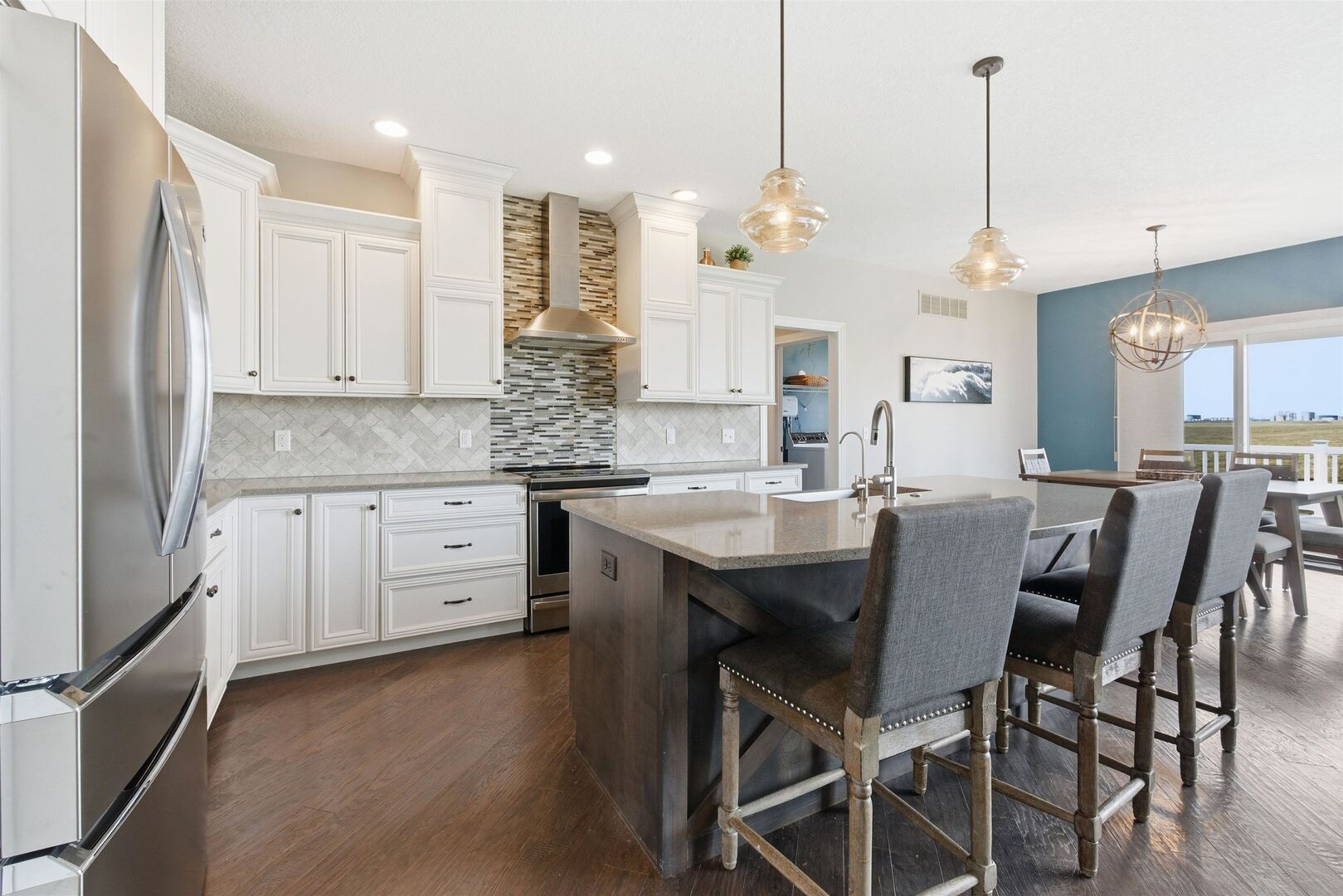 6478 Spring Creek Drive Bettendorf, IA 52722 - Photo 12 of 39 a kitchen with stainless steel appliances granite countertop a kitchen island a stove a table and chairs
