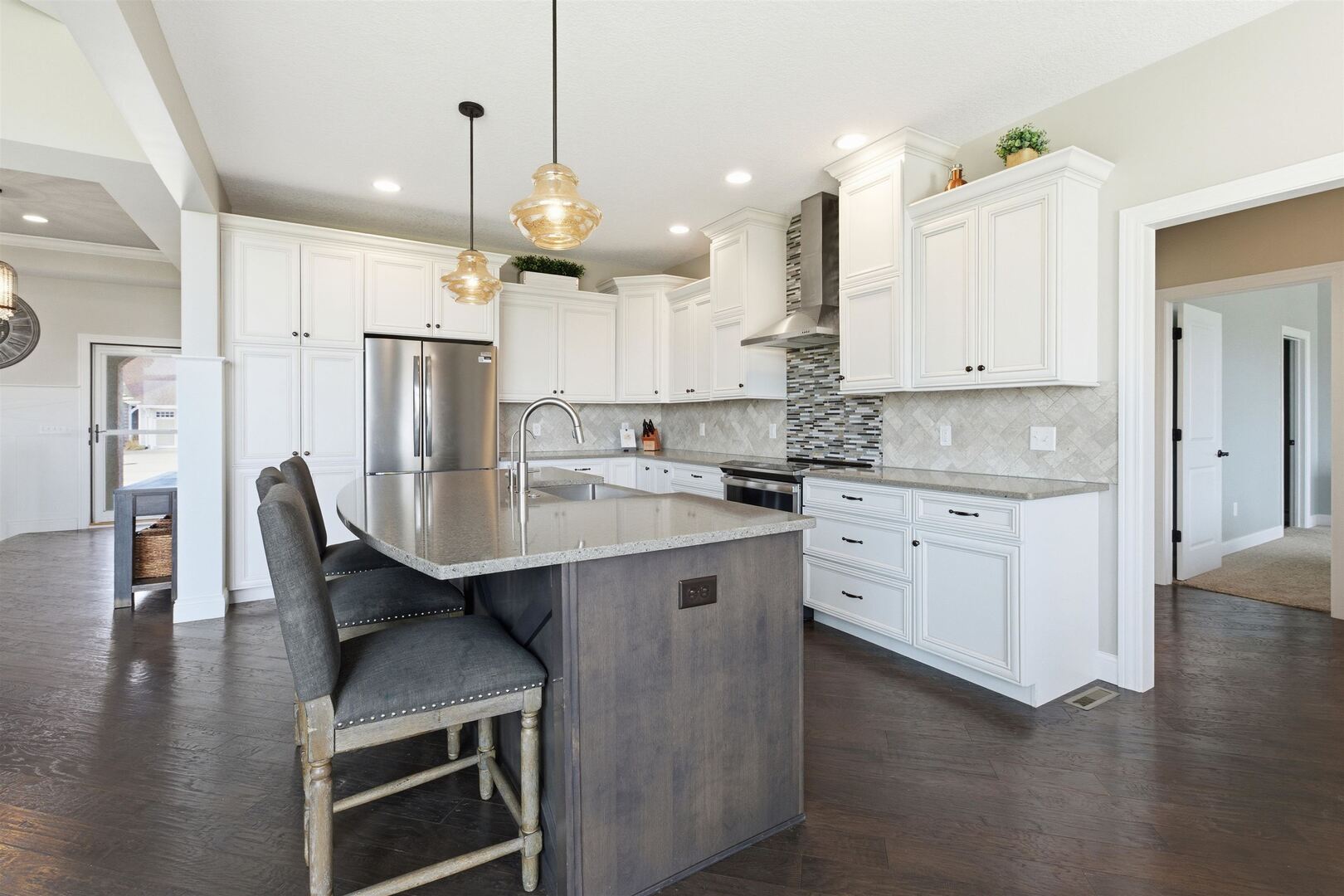 6478 Spring Creek Drive Bettendorf, IA 52722 - Photo 13 of 39 a kitchen with stainless steel appliances kitchen island granite countertop a table chairs refrigerator and microwave