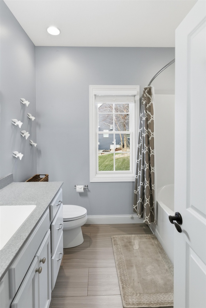 6478 Spring Creek Drive Bettendorf, IA 52722 - Photo 26 of 39 a bathroom with a sink a toilet and a shower