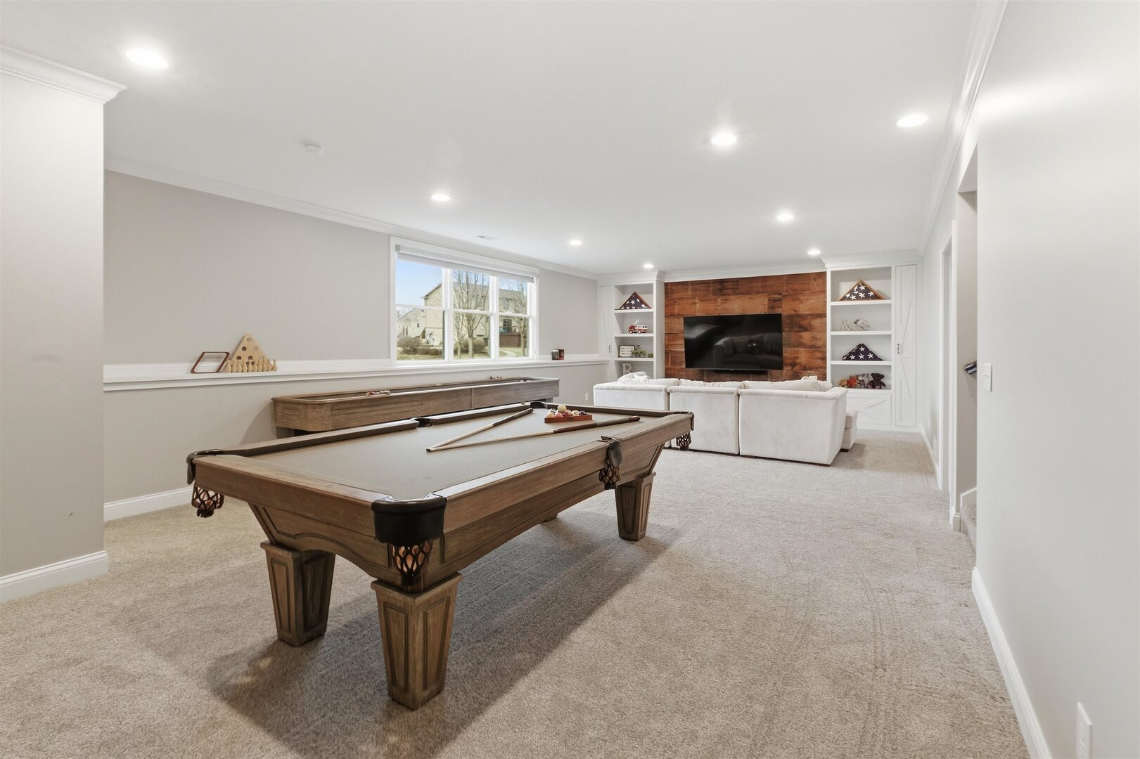 6478 Spring Creek Drive Bettendorf, IA 52722 - Photo 29 of 39 a living room with furniture a flat screen tv and a table