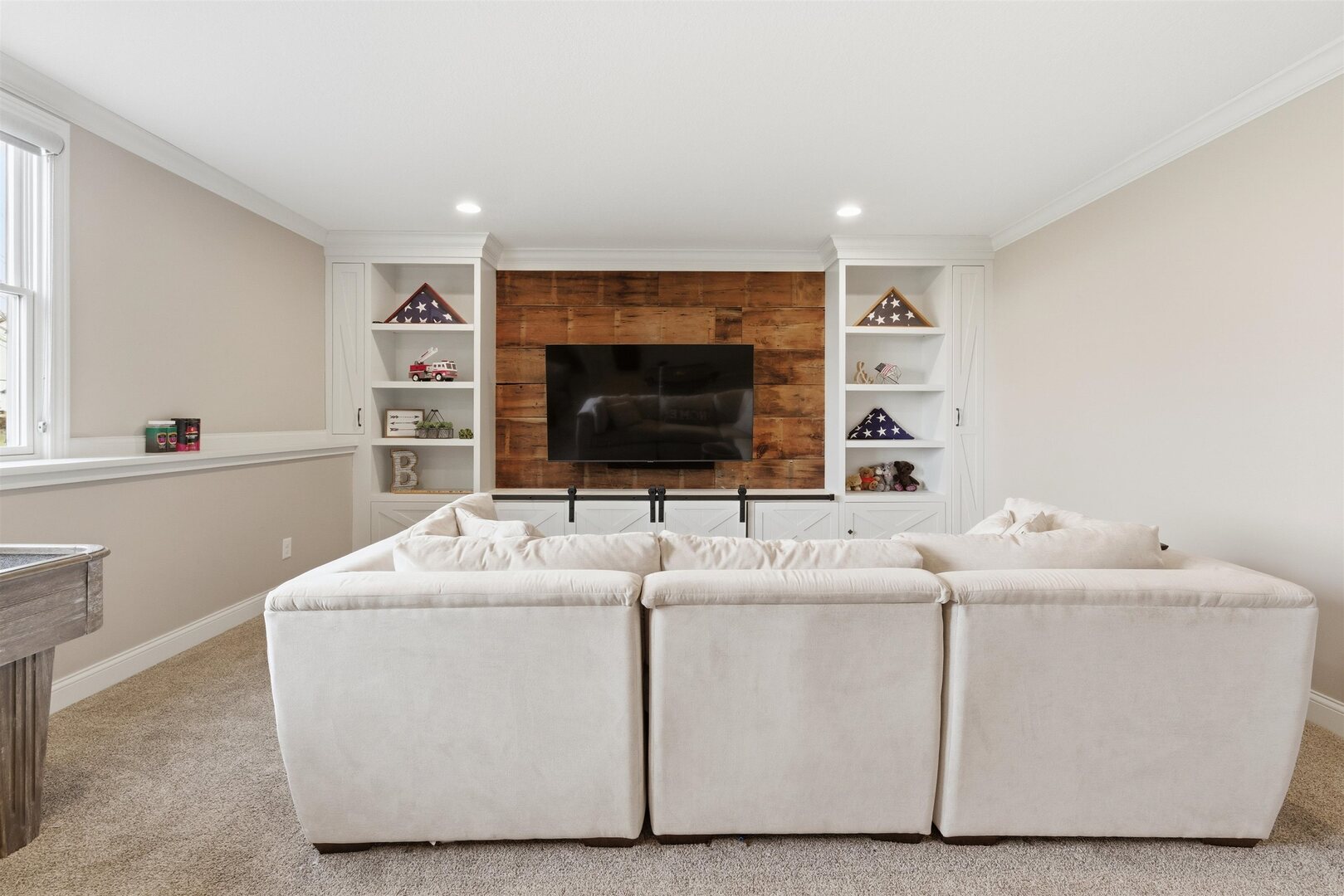6478 Spring Creek Drive Bettendorf, IA 52722 - Photo 30 of 39 a living room with furniture and a flat screen tv