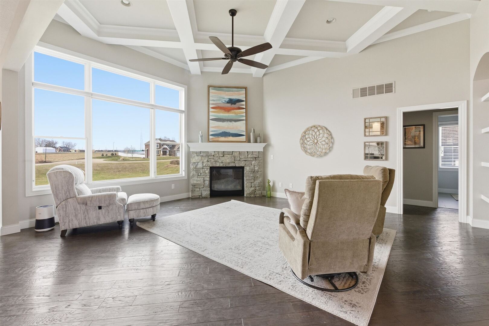 6478 Spring Creek Drive Bettendorf, IA 52722 - Photo 8 of 39 a living room with furniture floor to ceiling window and a clock