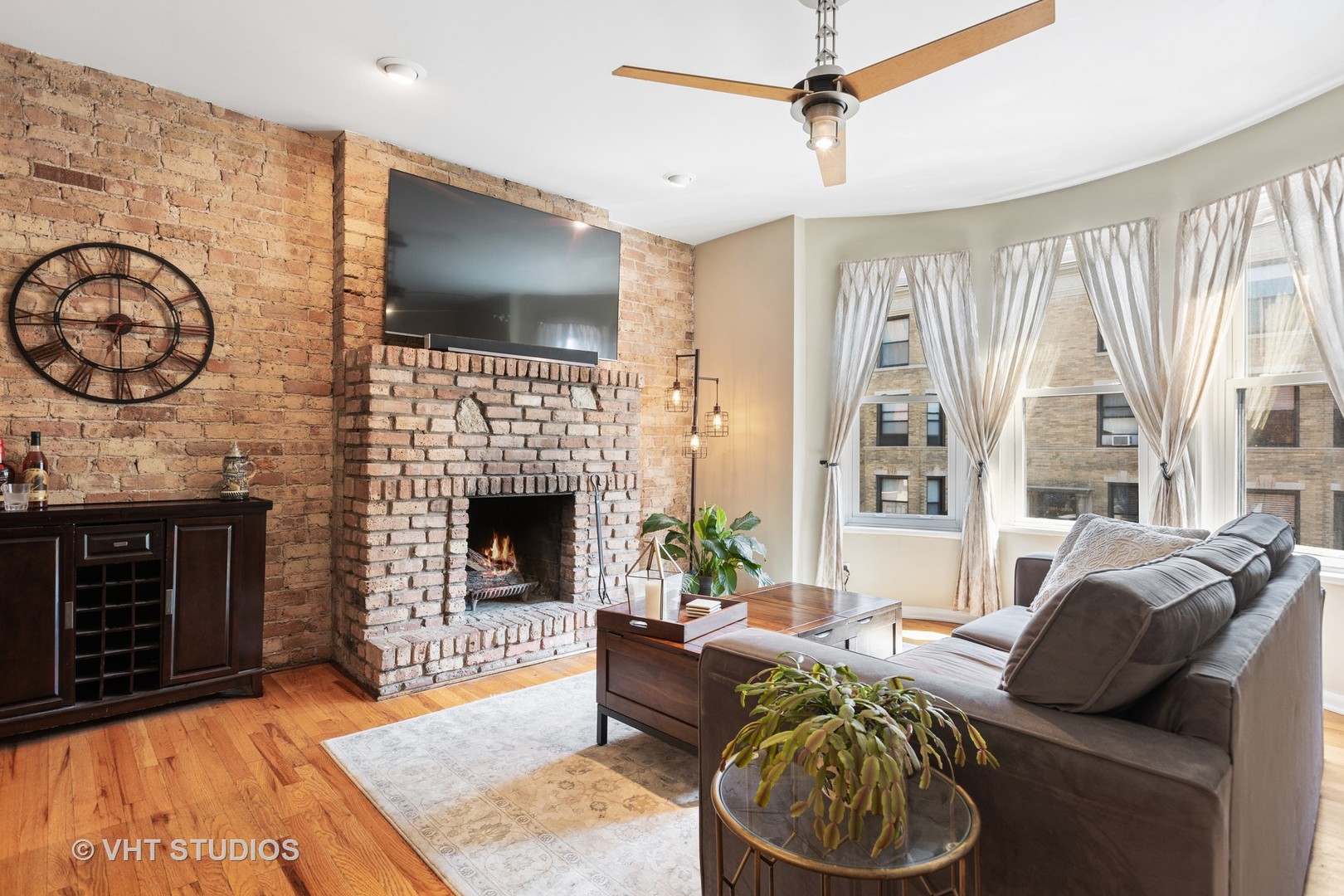 2956 North Halsted Street, Unit 2 Chicago, IL 60657 - Photo 2 of 13 a living room with furniture a flat screen tv and a fireplace