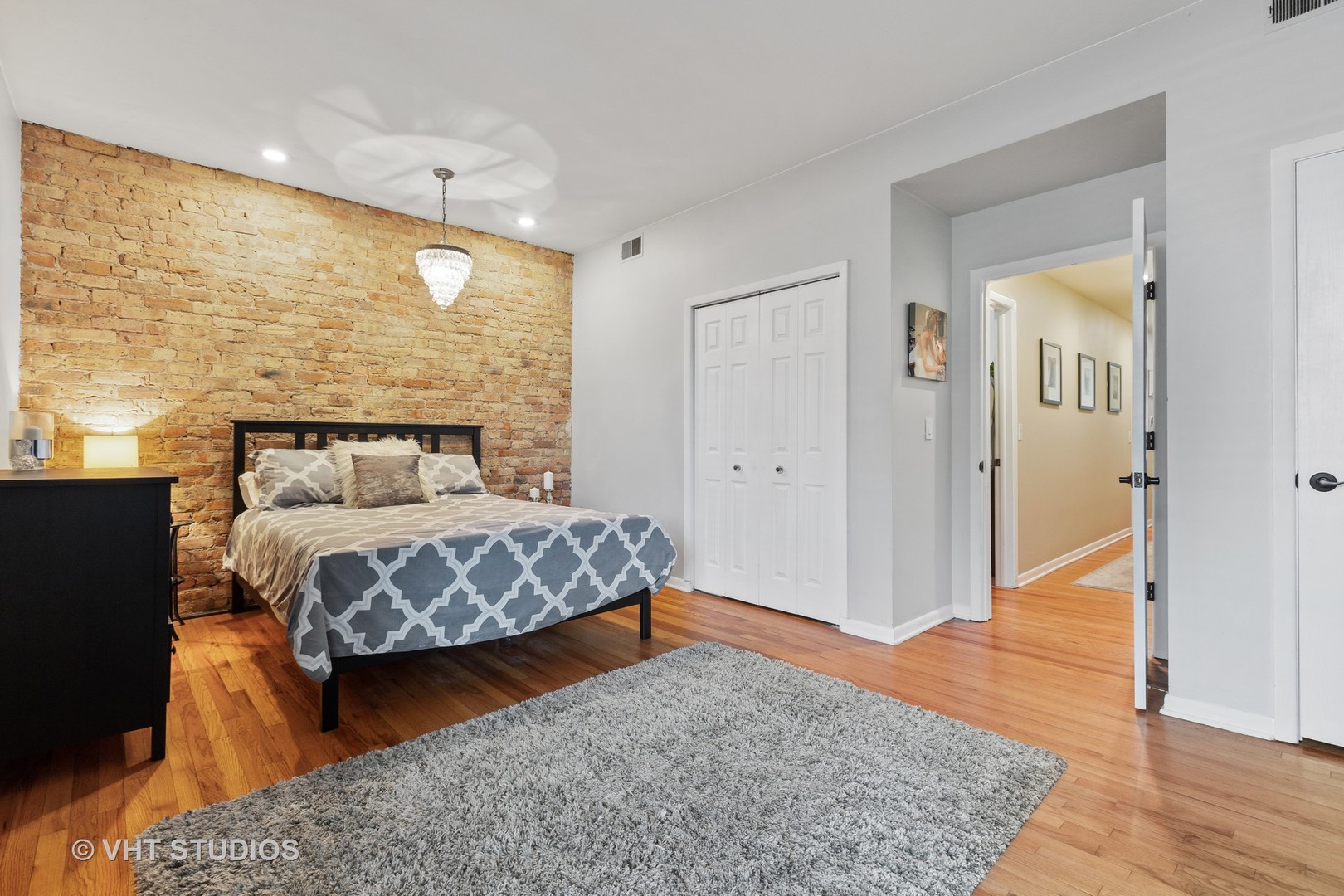 2956 North Halsted Street, Unit 2 Chicago, IL 60657 - Photo 11 of 13 a bedroom with a bed and wooden floor