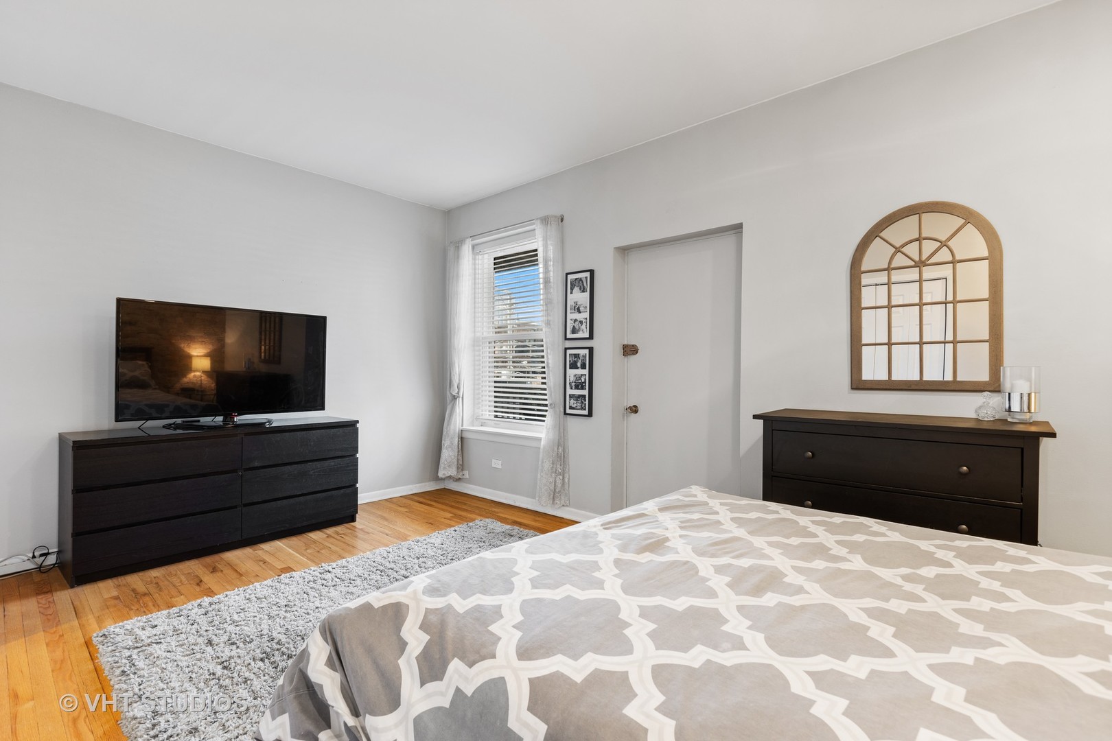 2956 North Halsted Street, Unit 2 Chicago, IL 60657 - Photo 12 of 13 a bedroom with a bed and a flat screen tv