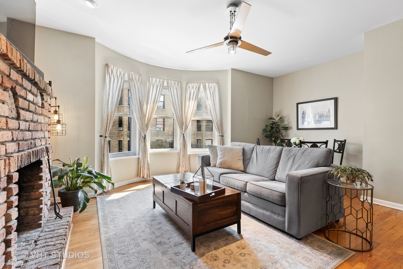 2956 North Halsted Street, Unit 2 Chicago, IL 60657 - Photo 3 of 13 a living room with furniture potted plant and a fireplace