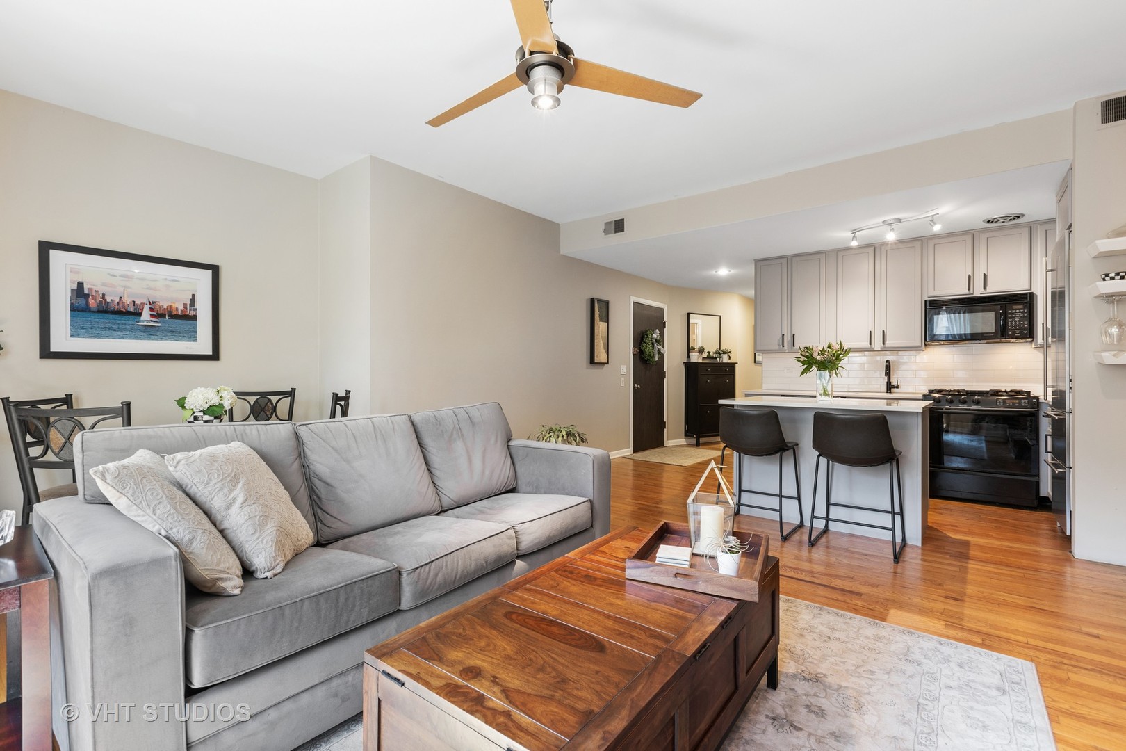 2956 North Halsted Street, Unit 2 Chicago, IL 60657 - Photo 4 of 13 a living room with furniture kitchen view and a wooden floor