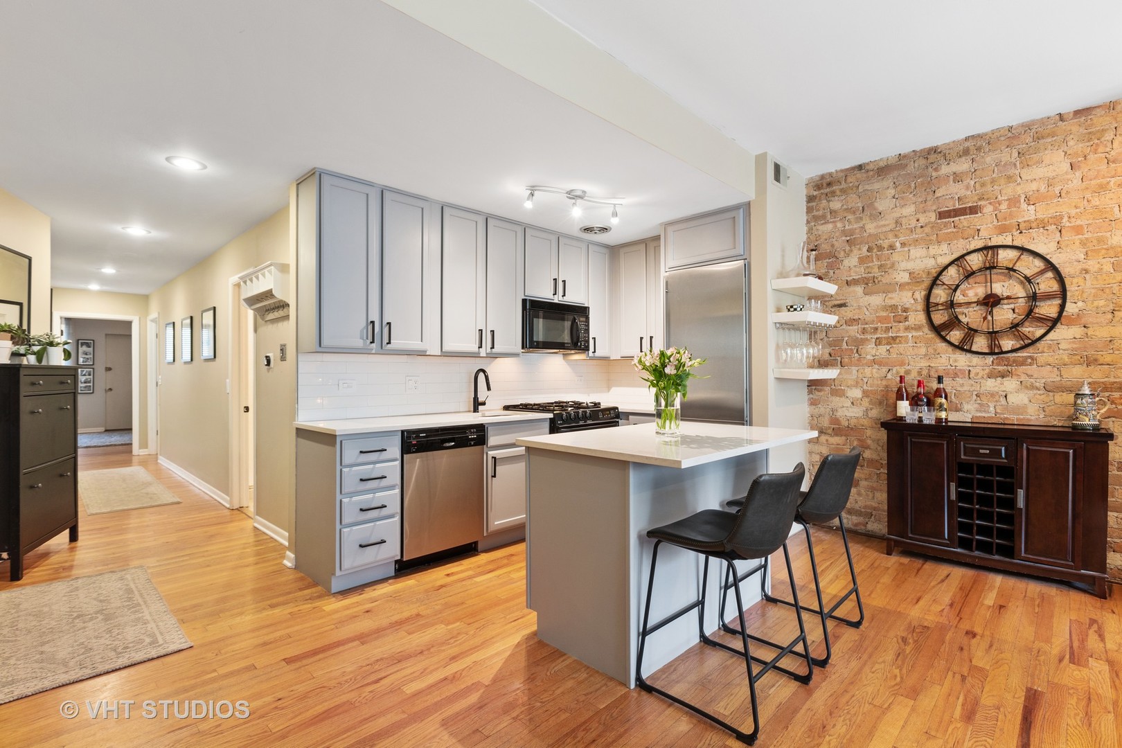 2956 North Halsted Street, Unit 2 Chicago, IL 60657 - Photo 6 of 13 a kitchen with a table chairs stove and refrigerator