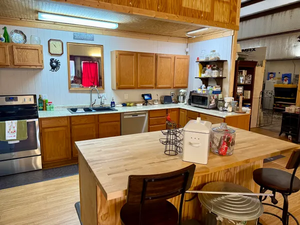 a large kitchen with a table and chairs in it