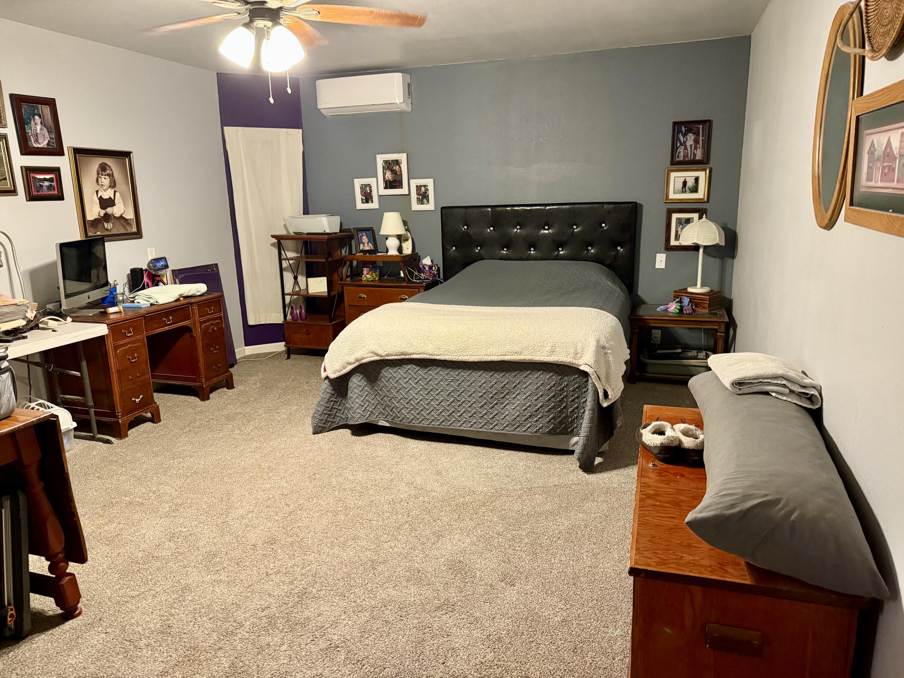 503 2nd Street Lorenzo, TX 79343 - Photo 7 of 13 a bedroom with a bed gym equipment and view of living room