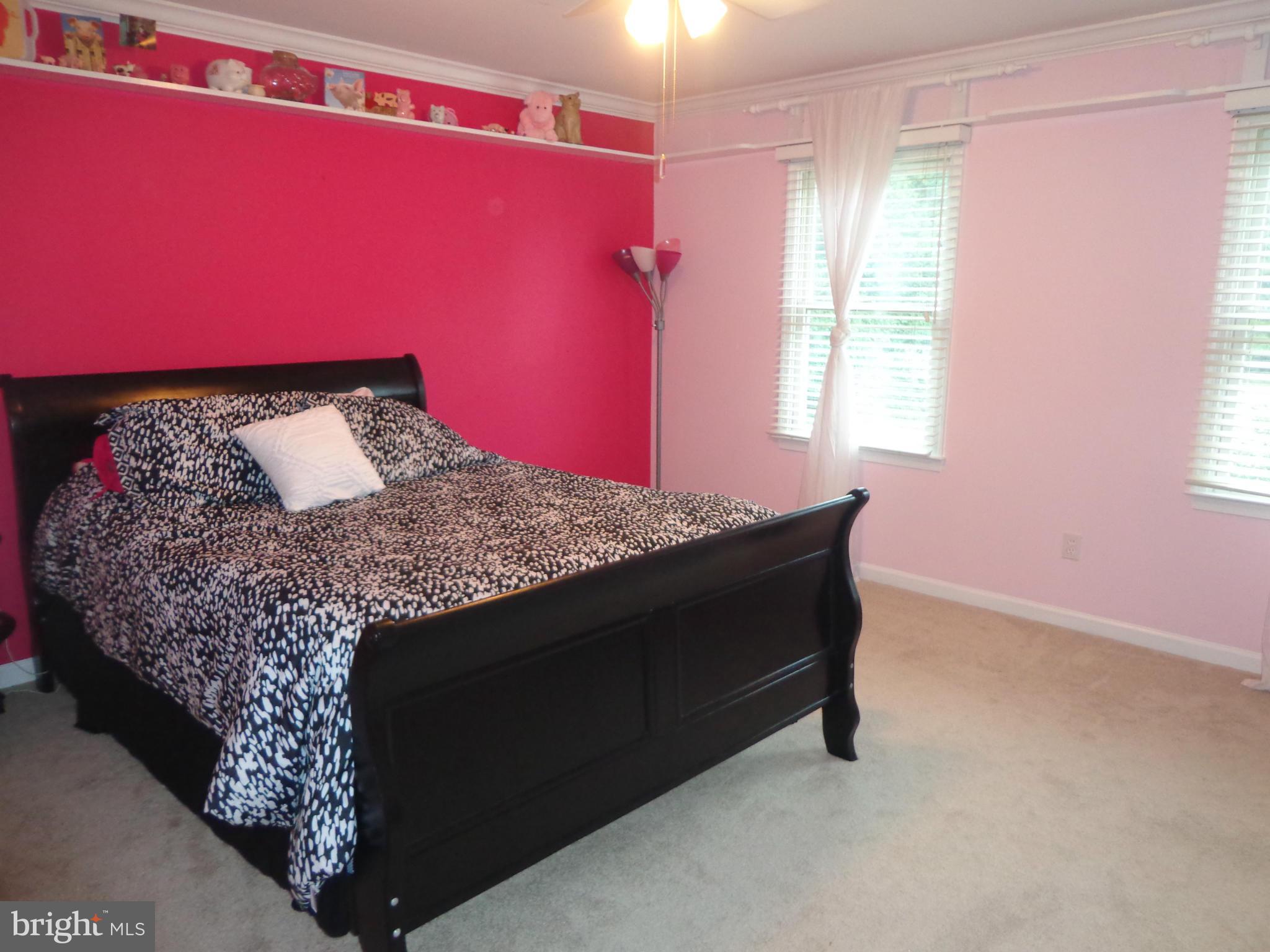 9323 Settle School Road Rixeyville, VA 22737 - Photo 15 of 30 a bed sitting in a bedroom next to a window