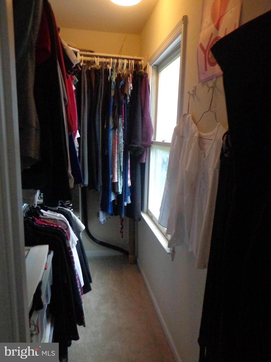 9323 Settle School Road Rixeyville, VA 22737 - Photo 24 of 30 a view of walk in closet with clothes and shoes