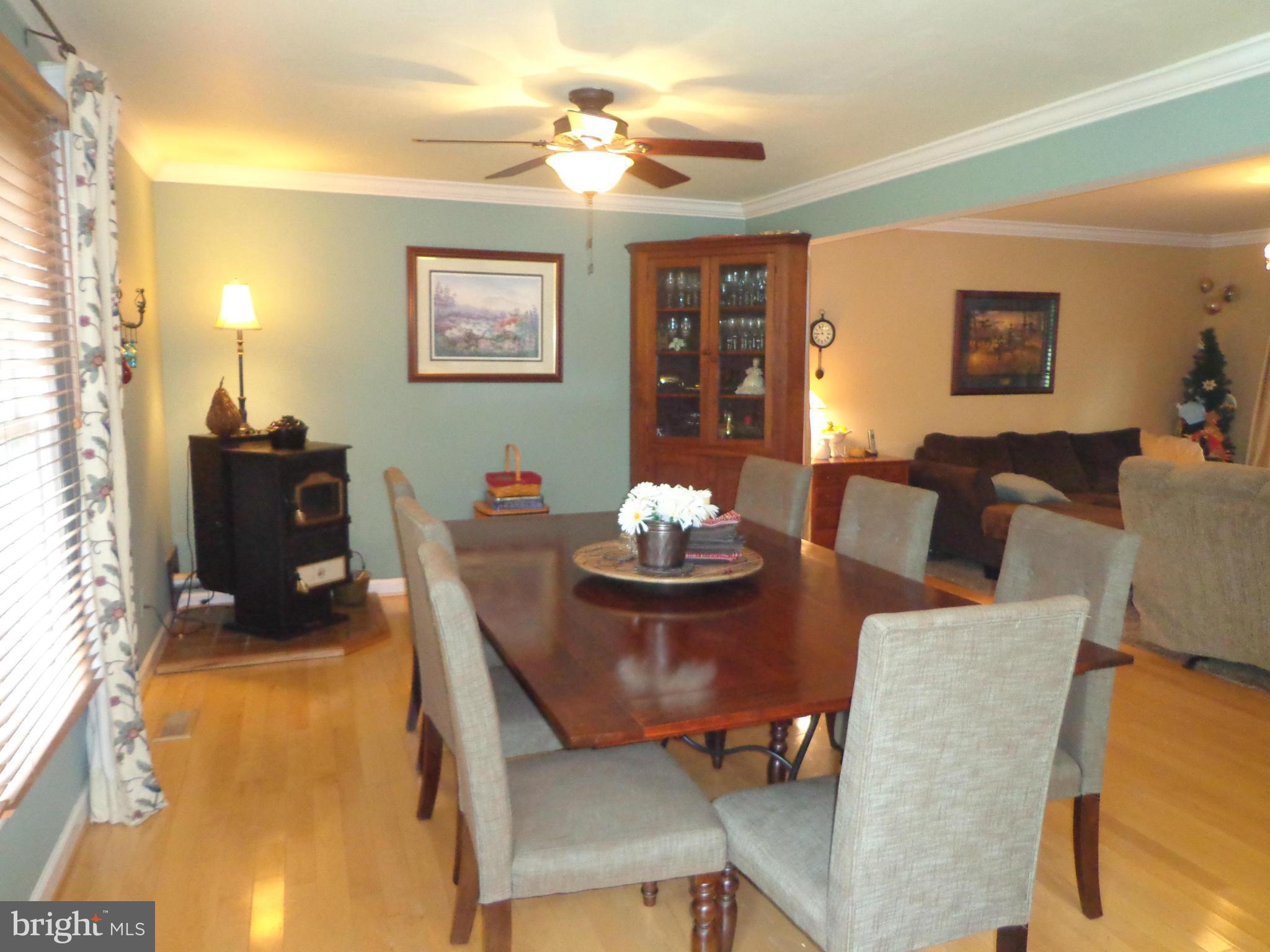 9323 Settle School Road Rixeyville, VA 22737 - Photo 10 of 30 a living room with furniture a chandelier and a dining table