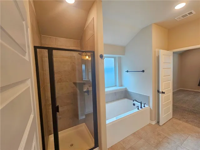 a bathroom with a bathtub and a shower