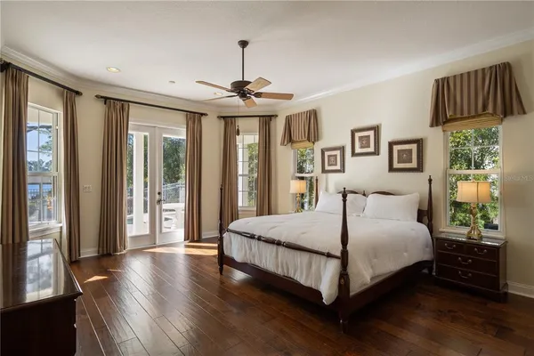 a bedroom with a bed and a chandelier