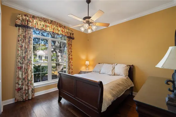 a view of a room with a chandelier fan and windows