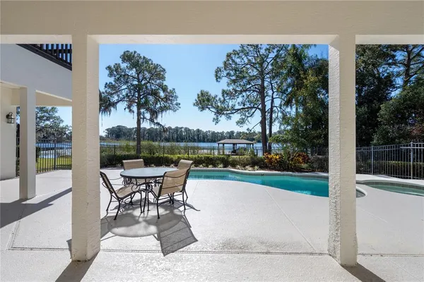 a view of a house with a yard balcony and swimming pool