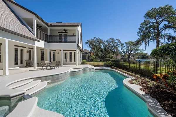 a backyard of a house with lots of green space and lake view