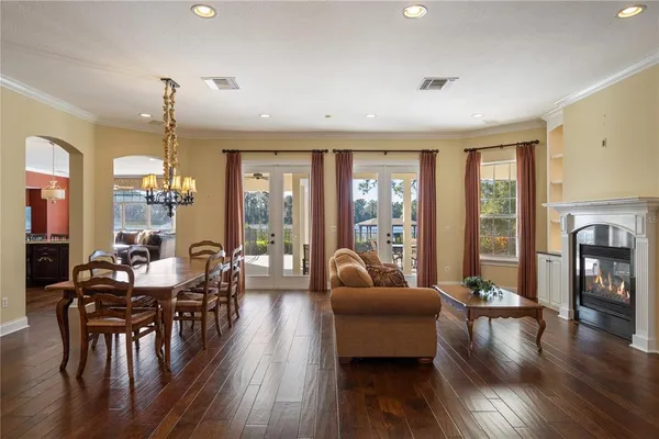 a living room with fireplace furniture and a wooden floor