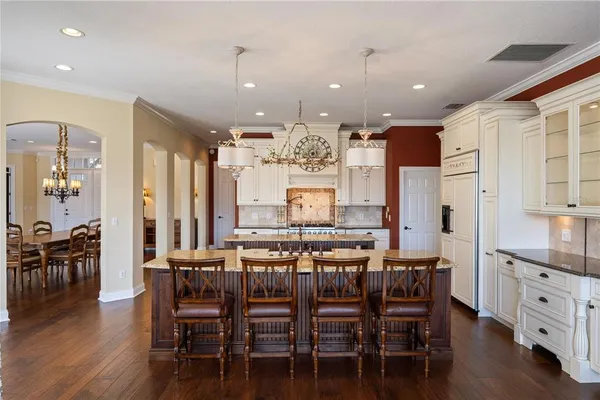 a large kitchen with a table and chairs