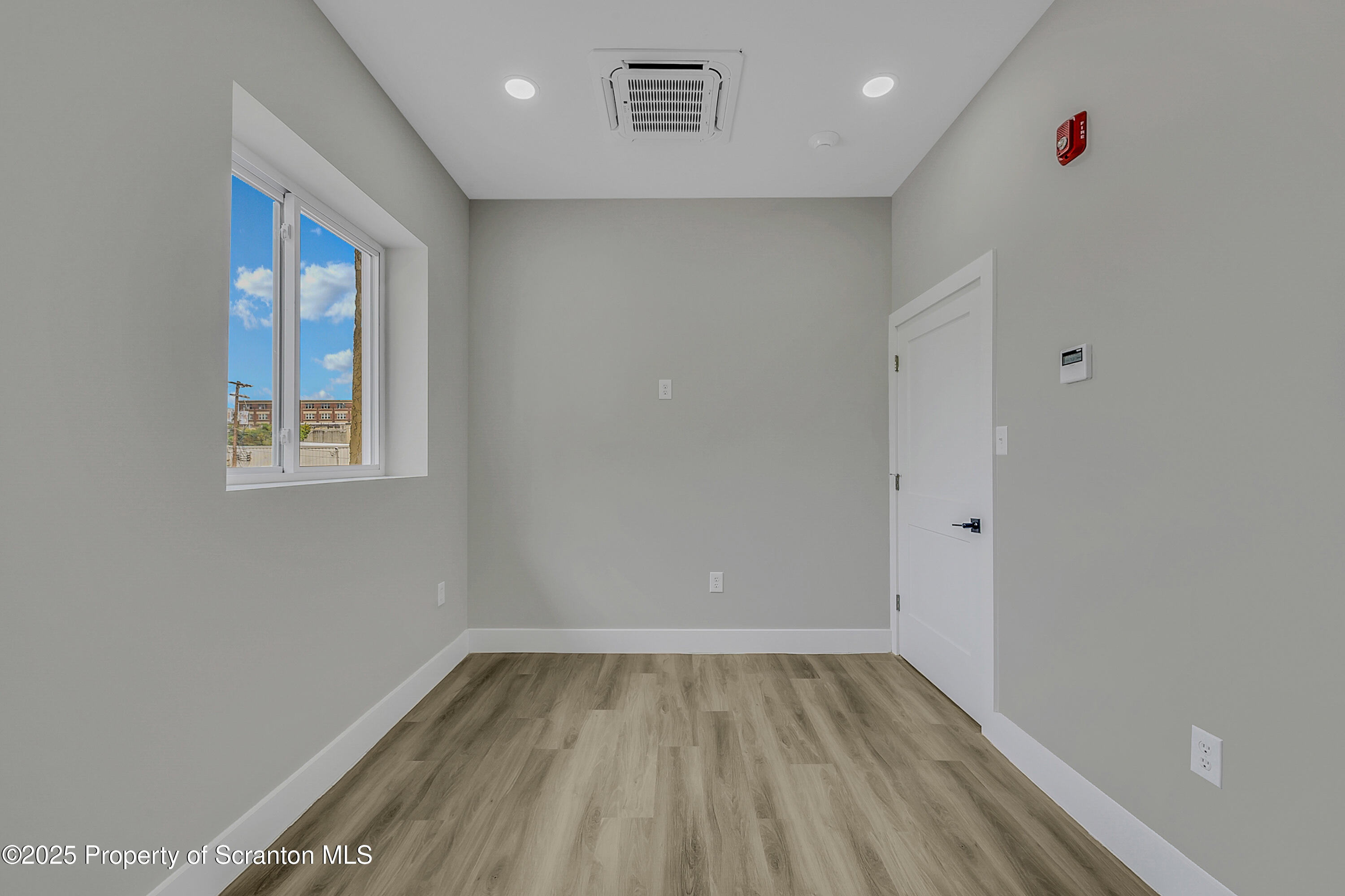 215 Hickory Street, Unit 9 Scranton, PA 18505 - Photo 12 of 19 a view of empty room with wooden floor and fan