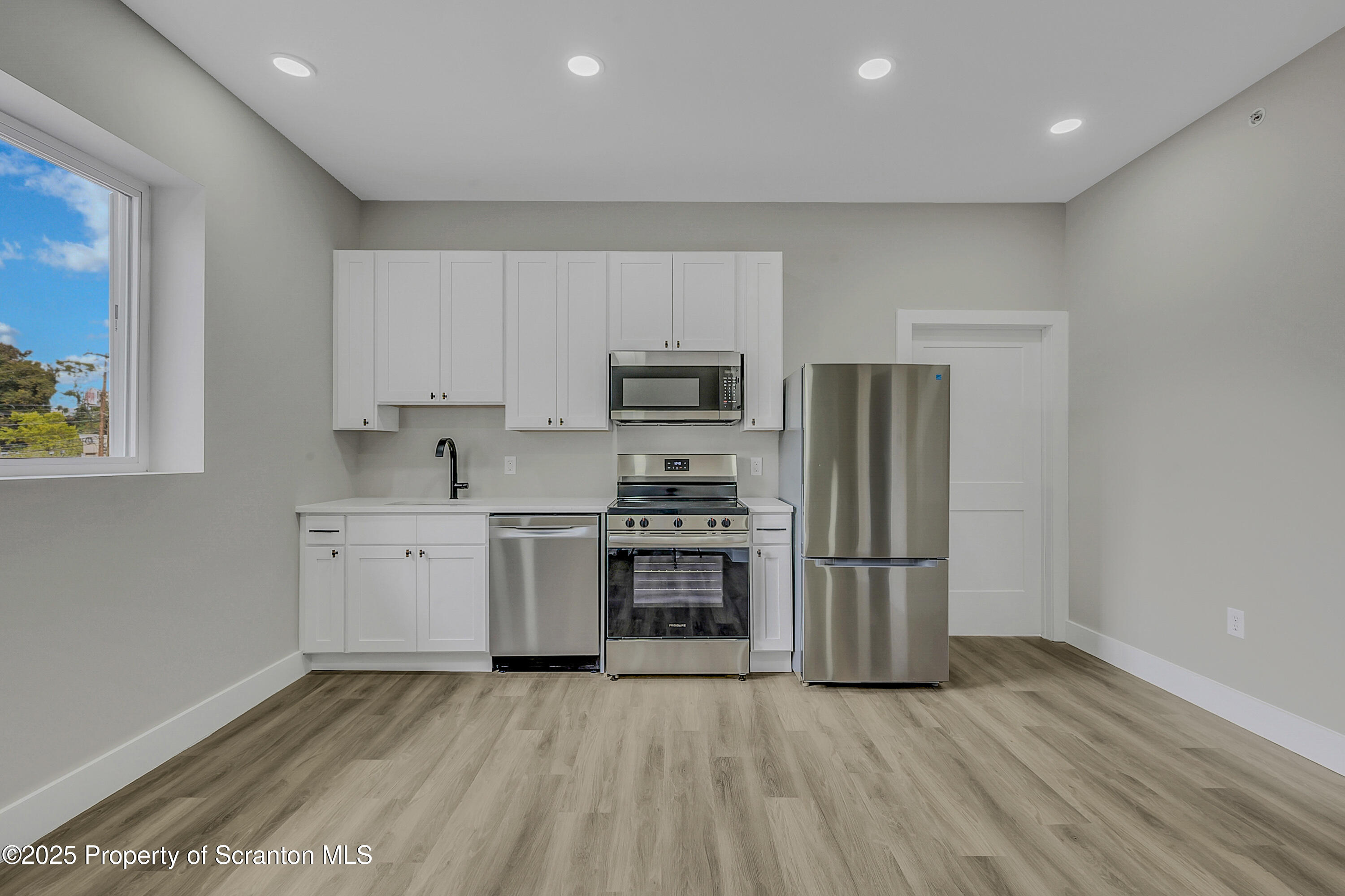 215 Hickory Street, Unit 9 Scranton, PA 18505 - Photo 2 of 19 a kitchen with stainless steel appliances granite countertop a stove a sink and a refrigerator