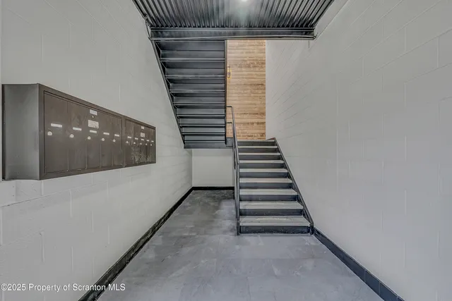 a view of a hallway with stairs