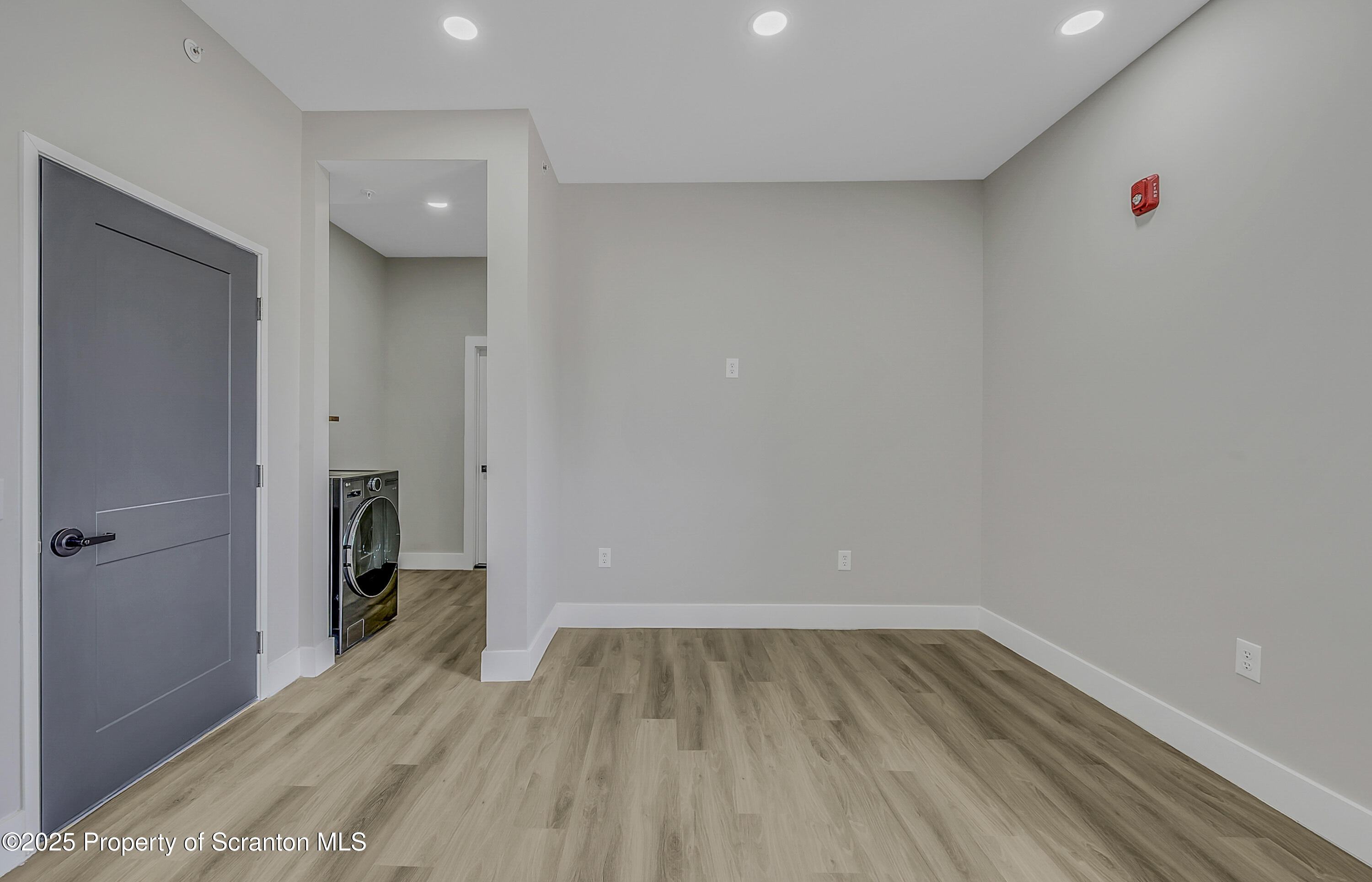 215 Hickory Street, Unit 9 Scranton, PA 18505 - Photo 9 of 19 a view of a room with wooden floor and a hallway
