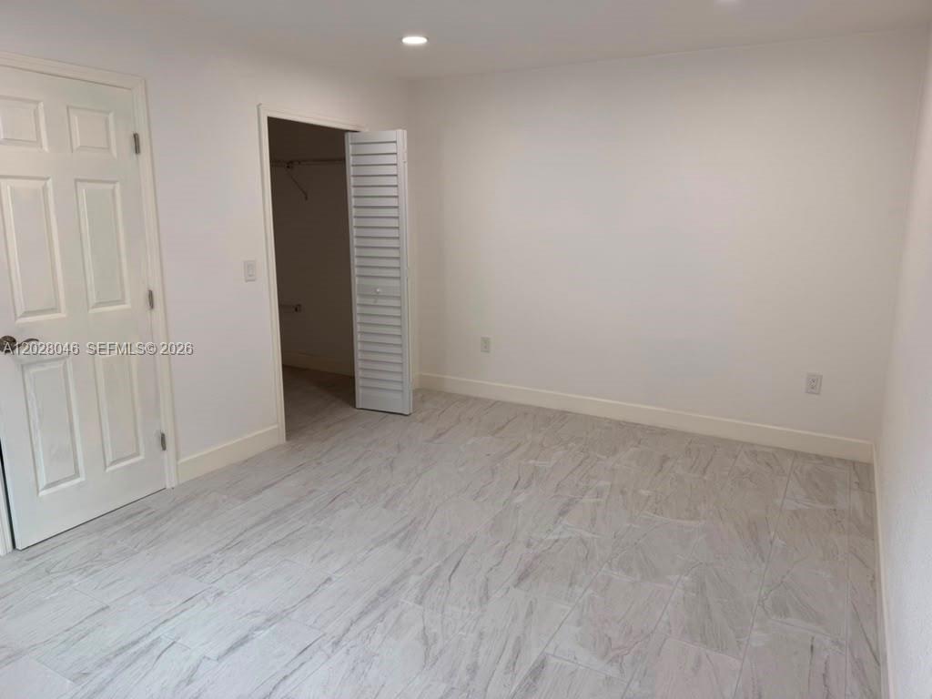 19321 Southwest 196th Street, Unit 1 Miami, FL 33187 - Photo 5 of 10 a view of an empty room with closet area
