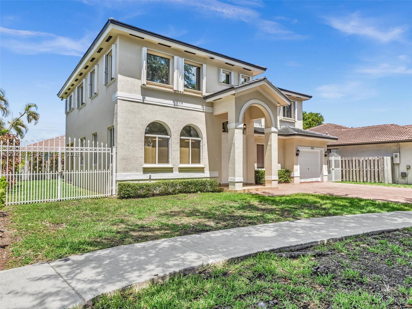 2864 Southwest 138th Path Miami, FL 33175 - Photo 2 of 40 a front view of a house with a garden