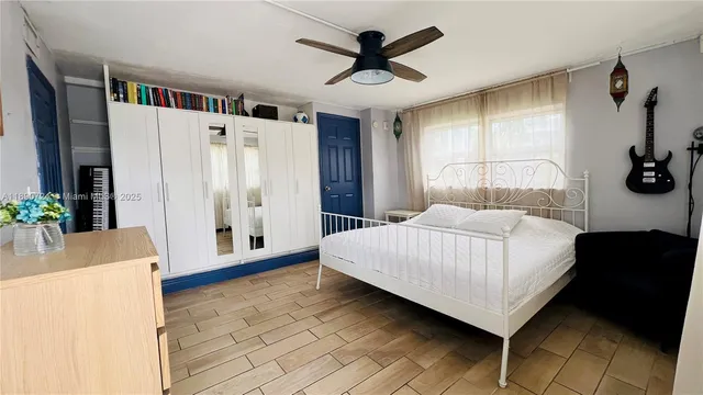 a bedroom with a large bed and a chandelier
