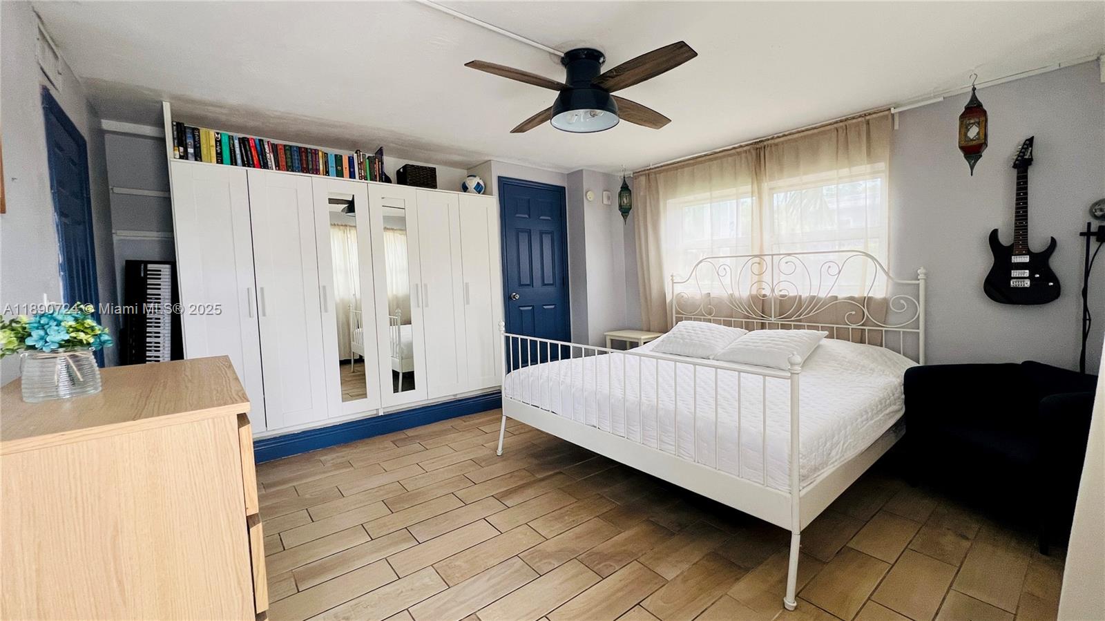 801 Meridian Avenue, Unit 1A Miami Beach, FL 33139 - Photo 11 of 18 a bedroom with a large bed and a chandelier