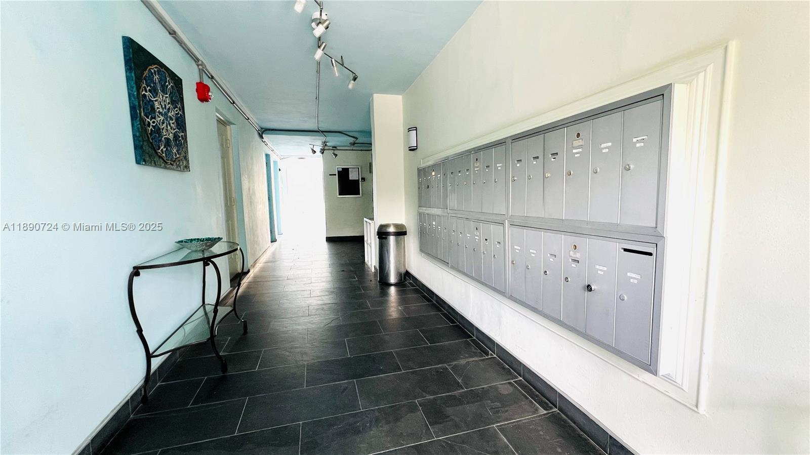 801 Meridian Avenue, Unit 1A Miami Beach, FL 33139 - Photo 14 of 18 a hallway with wooden floor a chandelier and entryway